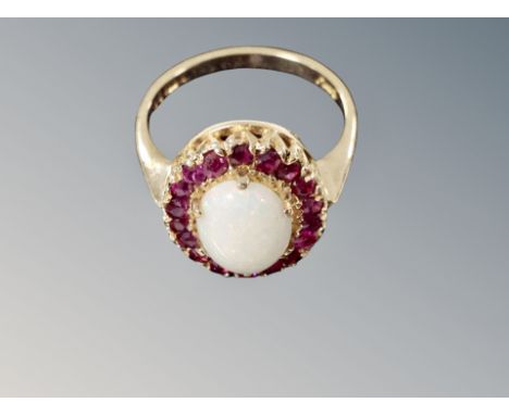 A ruby and opal cluster ring, size L, cluster dimensions 12.8 mm x 14.65 mm. CONDITION REPORT: We cannot very if the rubies a