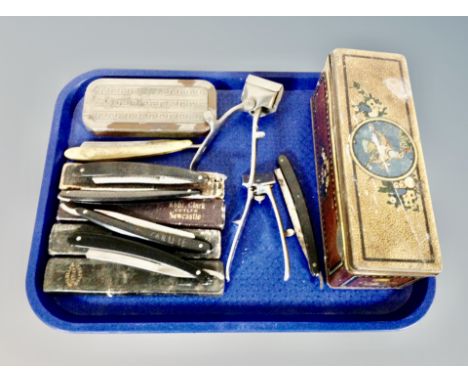 A vintage tin and a quantity of cut throat razors in cases, Rolls razor and clippers 