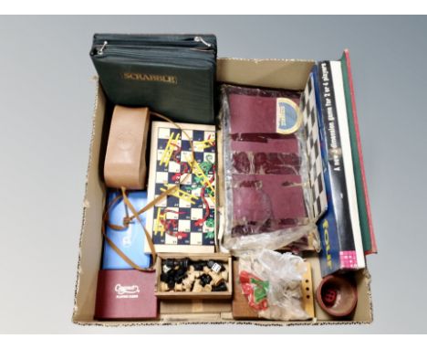 A box of vintage board games, playing cards, boxwood chess set 