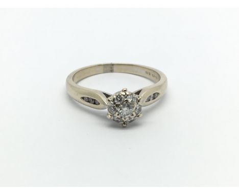 An 18carat gold ring set with a cluster of diamonds ring size P.