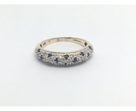 A 9carat gold ring set with a pattern of sapphire and diamonds ring size N-O