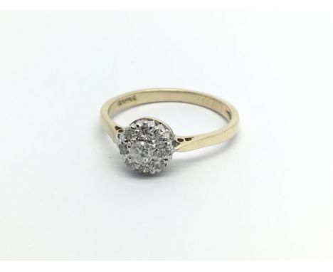 A 9carat gold ring set with a cluster of diamonds ring size O.