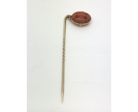 A Victorian gold and coral pulley stick pin, approx 3.1g.