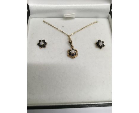 A 9 ct gold necklace and earring set inset with sapphire and opal.