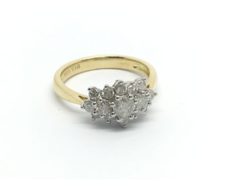 An 18carat gold ring set with a cluster of diamonds approximately 1.00 one carat of diamonds ring size N-O