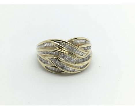 A 9carat gold ring set with a pattern of baguette diamonds ring size T