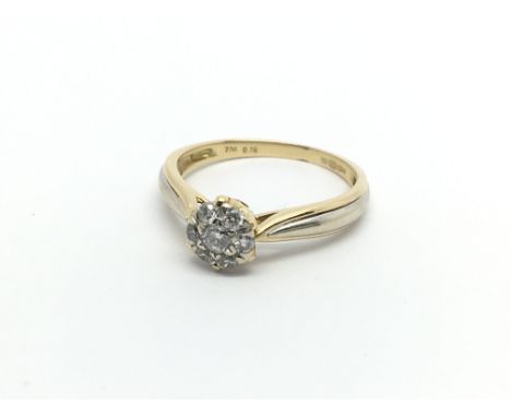 An 18carat gold ring set with a round cluster of diamonds ring size L-M