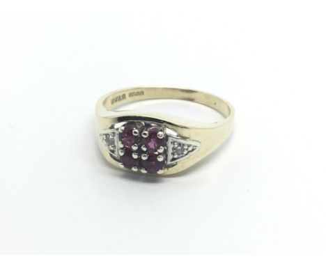 A 9carat gold ring set with a pattern of ruby and diamonds. ring size O.