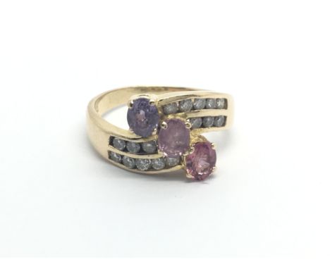 An unusual 9carat gold ring set with pink sapphire amethyst and four rows of brilliant cut diamonds ring sizeM