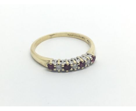 An 18carat gold ring set with an alternating row of ruby and diamonds ring size O