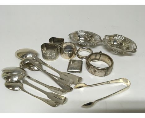 A collection of silver oddments spoons a Vesta vase silver bangle napkin rings dishes and a pair of sugar tongs.