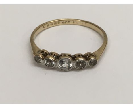 A 9 ct gold ring inset with a a row of five stones size O.