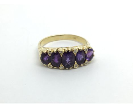 An 18carat gold ring set with a row of Amethyst stones ring size P.