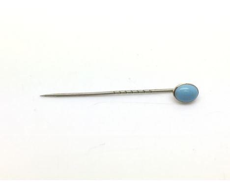 A Victorian gold stick pin with a turquoise top.