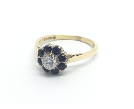 An 18carat gold ring set with a central brilliant cut diamond approximately 0.35 of a carat flanked in a circular pattern wit