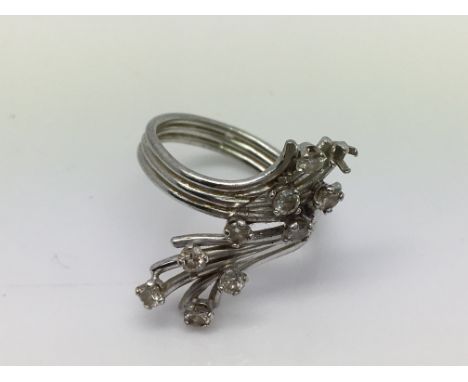 A white metal and diamond set ring ( 1stone missing). Approx 4.3g. (L).