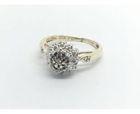 A 9carat gold ring set with a cluster of diamonds ring size J-K