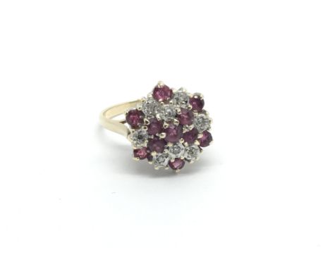 A 9carat gold ring set with a pattern of ruby and diamonds ring size N.