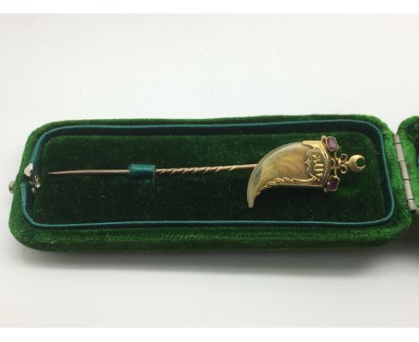 A cased Victorian Indian gold stick pin in the form of a claw set with two rubies, approx 2g.