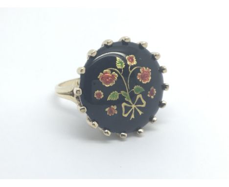 A 9carat gold ring set with enamelled jet. Ring size N-O