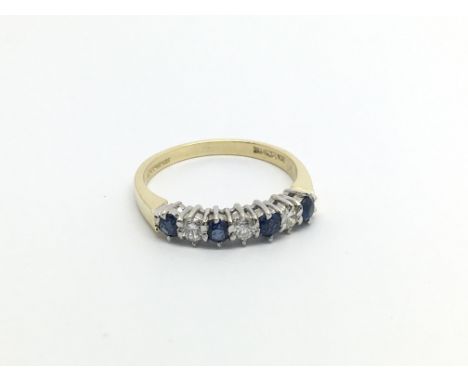 An 18carat gold ring set with alternating sapphire and diamonds ring size M.