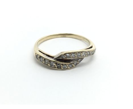 An unmarked gold ring set with diamonds ring size Q-R