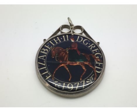 A silver and enamel crown coin pendant.