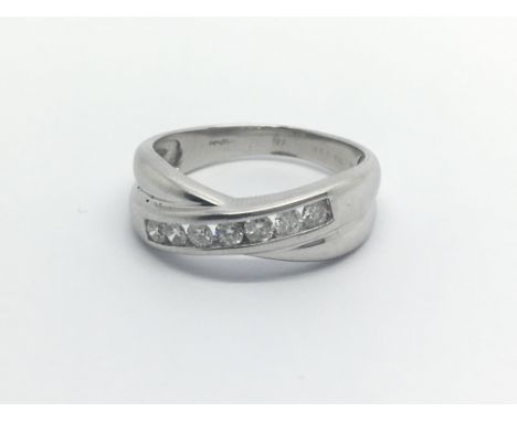 An 18carat white gold ring set with a row of brilliant cut diamonds Approximately 0.33 of a carat size N-O.