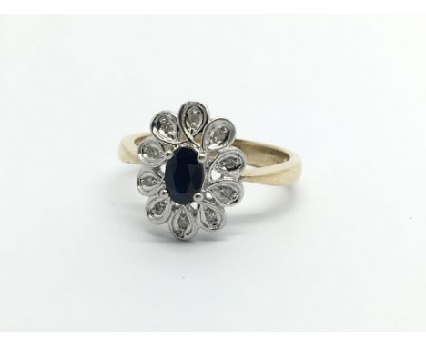 A 9carat gold ring set with a blue sapphire and small chip stone diamonds ring size O-P