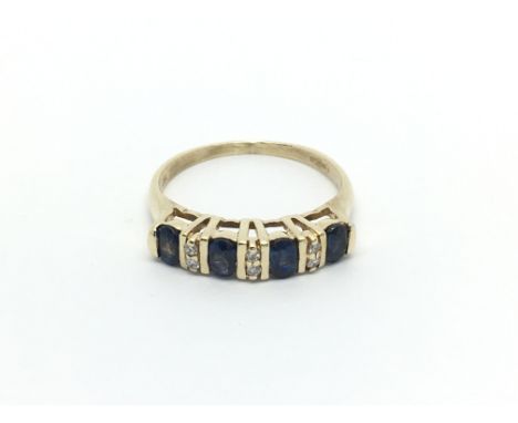 A 9carat gold ring set with blue sapphire and diamonds ring size N