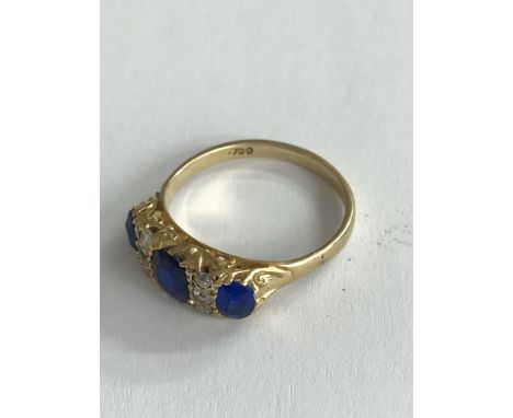 An 18ct gold diamond and blue stone set ring. (p).