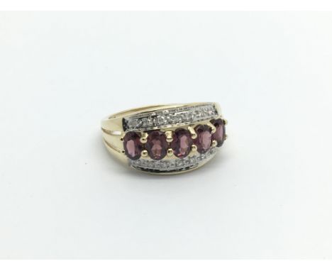 A 9carat gold ring set with almandine garnets and small diamonds ring size H