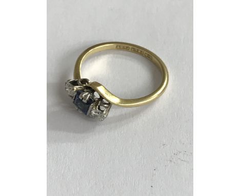 An 18ct gold and platinum square cut sapphire and diamond set ring. (L)