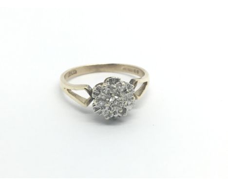 A 9carat gold ring set with a cluster of diamonds ring size O.