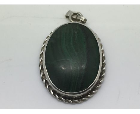 A silver and malachite pendant.