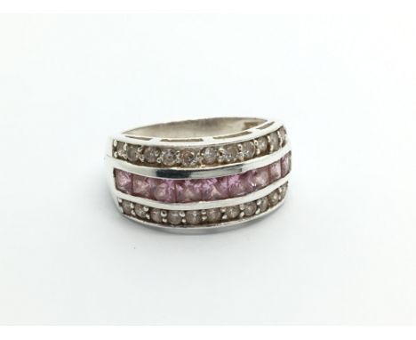 A silver ring set with pink and white CZ stones ring size R