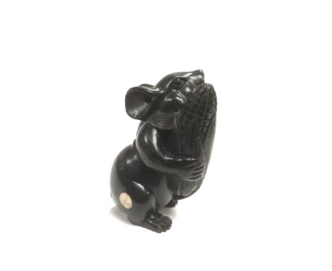 A carved and ebonised netsuke of a mouse holding an ear of corn, approx 4.5cm.