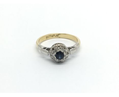 An 18carat gold and platinum ring set with a sapphire and diamonds ring size N.