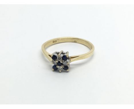 An 18carat gold ring set with a square pattern of sapphire and diamonds ring size M