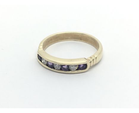 A 9carat golf half hoop eternity ring set with alternating amethyst and brilliant cut diamonds ring size M-N