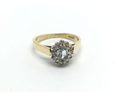 An 18carat gold ring set with an aquamarine type stone flanked by diamonds. ring size J.