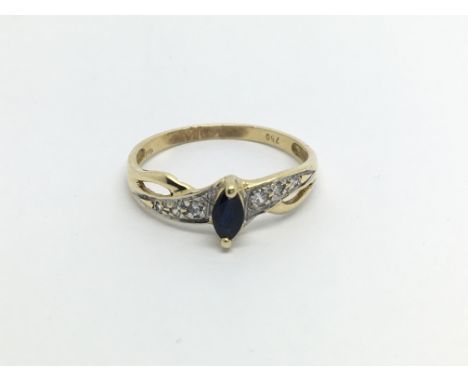 An 18carat gold ring set with a sapphire flanked by diamonds ring size N