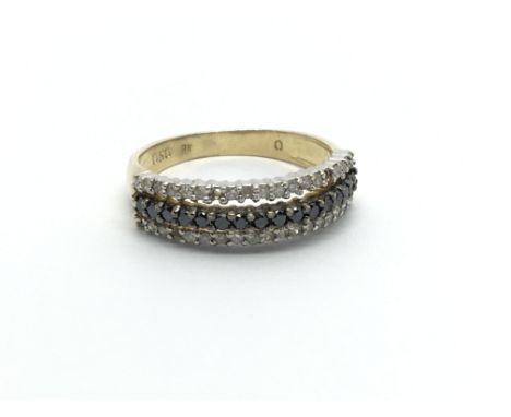 A 9carat gold ring set with a row of black diamonds in between two rows of white diamonds. ring size N-O.