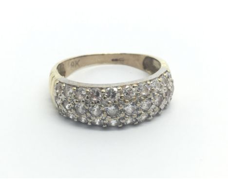 A 9carat gold ring set with three rows of diamonds approximately 0.50 of a carat ring size N-O