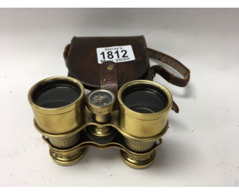 A pair of brass binoculars by Lawrence &amp; Mayo, ÒThe LynxÓ, with built in compass and lather case.