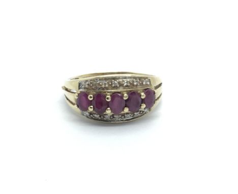 A 9carat gold ring set with ruby and small diamonds ring size M-N