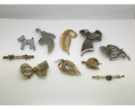 Ten costume brooches including an opal bar brooch example, leaf design etc.