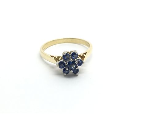 An 18carat gold ring set with a cluster of Ceylon sapphire. ring size N-On