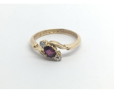 A Vintage 18carat gold ring set with a ruby flanked by two brilliant cut diamonds ring size O.