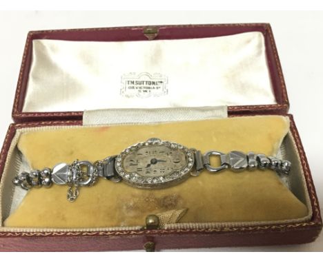 An Art Deco Platinum and diamond set ladies watch with a replacement Crome finish strap not seen working in a fitted box.